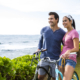 Couple looking out to the ocean on their bikes